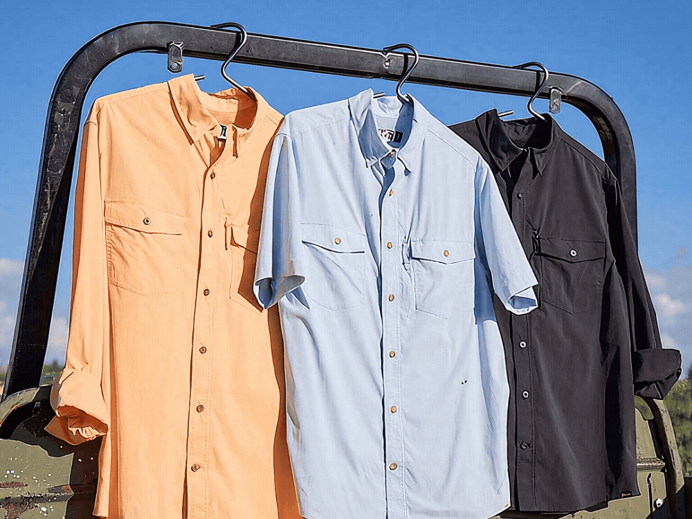 Three men's button-down shirts hanging outside.