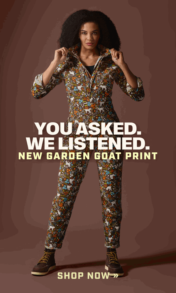 Woman wearing coveralls with goat and flower pattern.