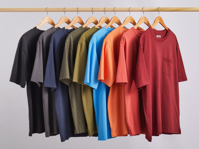 Multiple men's t-shirts hanging up.
